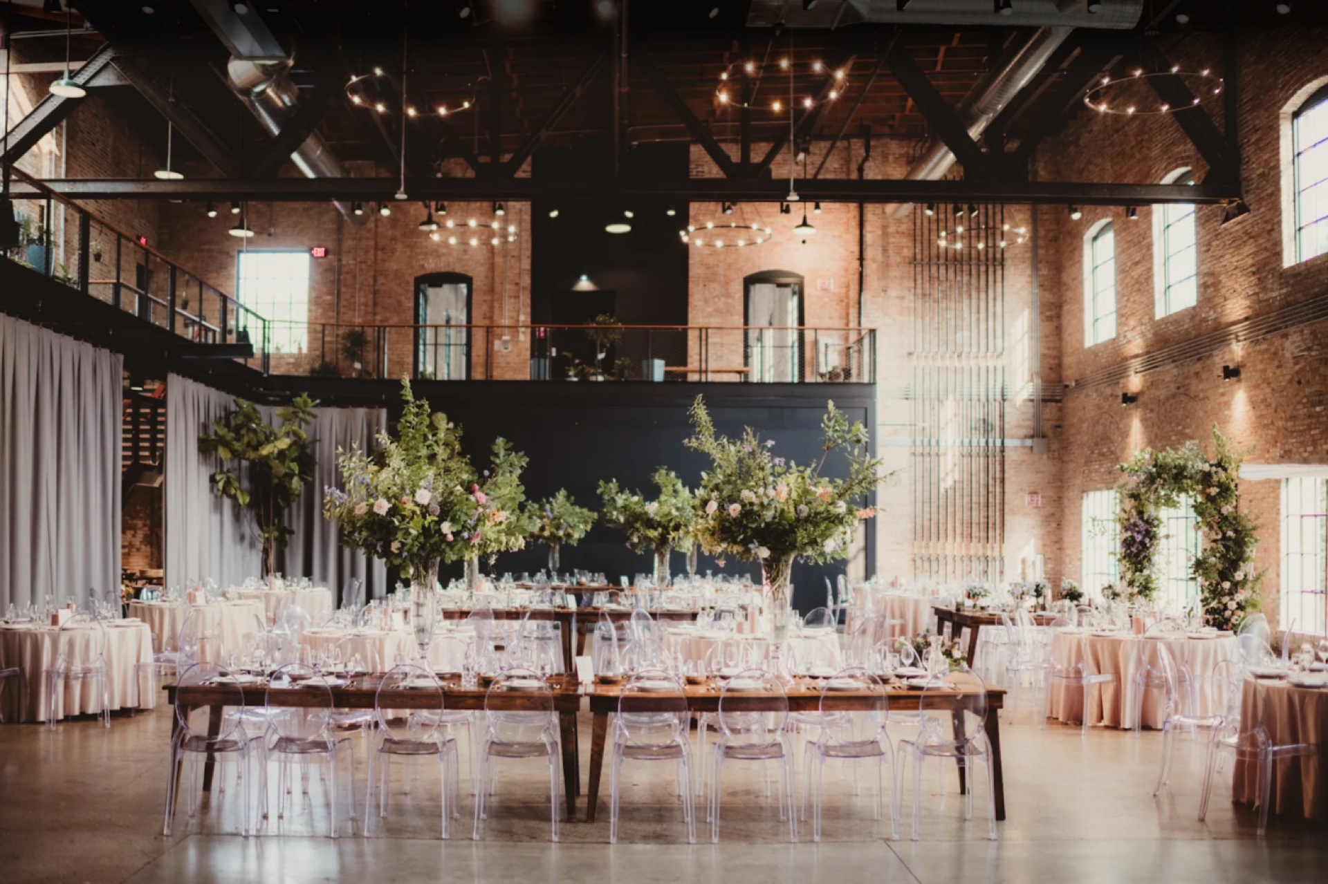 Elegant wedding reception setup inside the Garver Feed Mill atrium with warm lighting
