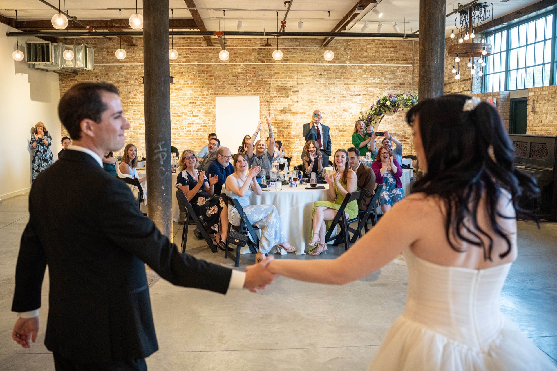 Bride and groom dancing in the Garver Canvas gallery